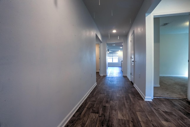 corridor with baseboards and dark wood-style flooring
