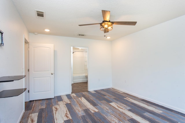 spare room featuring baseboards, visible vents, wood finished floors, and a ceiling fan