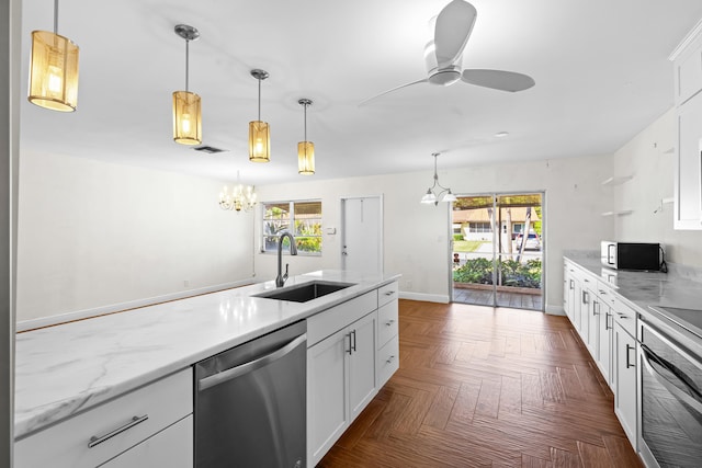 kitchen with a sink, stainless steel appliances, a wealth of natural light, and white cabinets