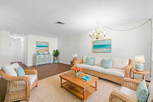 living room with visible vents, baseboards, and an inviting chandelier