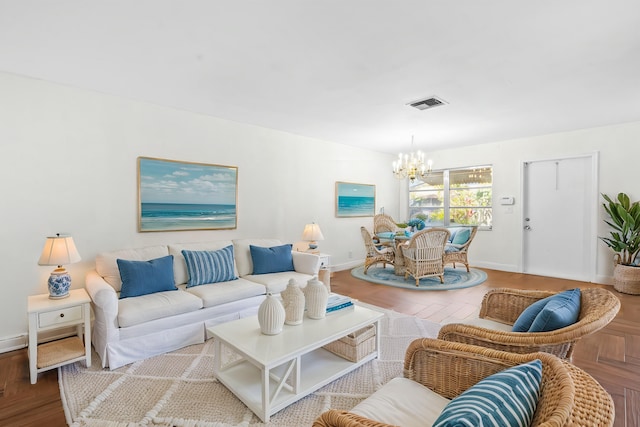 living area featuring an inviting chandelier, baseboards, and visible vents