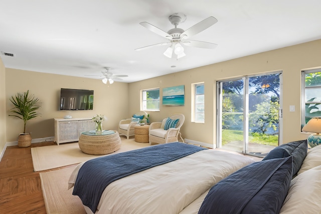 bedroom with visible vents, baseboards, a ceiling fan, and access to outside