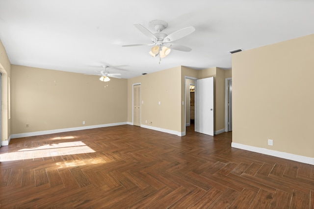 spare room with baseboards, visible vents, and ceiling fan