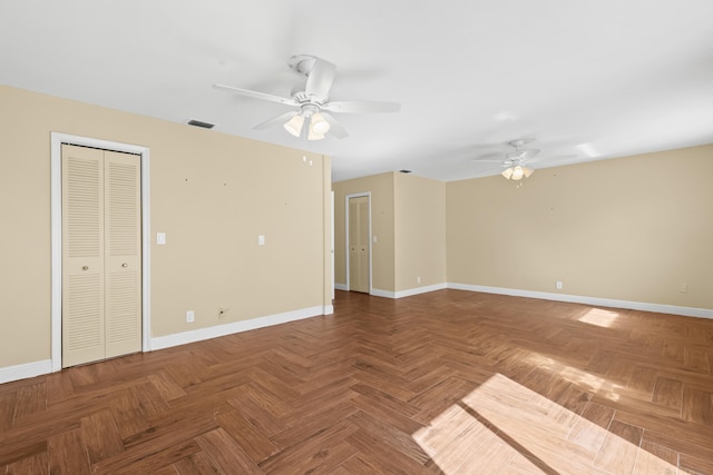 unfurnished room featuring a ceiling fan, visible vents, and baseboards