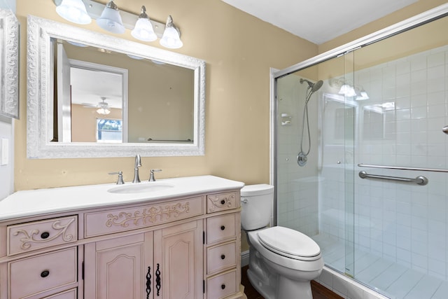 full bath with vanity, toilet, and a shower stall