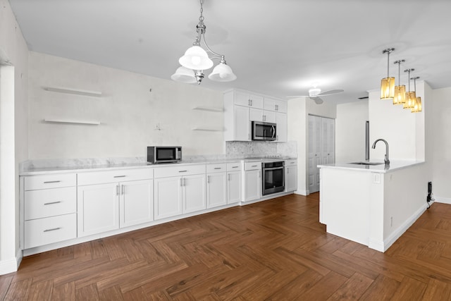 kitchen featuring open shelves, a sink, white cabinetry, stainless steel appliances, and ceiling fan