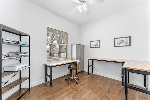 office area featuring ceiling fan, hardwood / wood-style floors, and baseboards