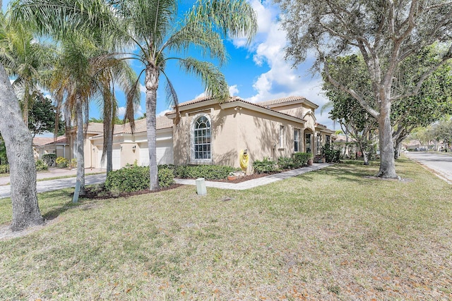 view of front of home featuring a garage, driveway, a tiled roof, stucco siding, and a front lawn