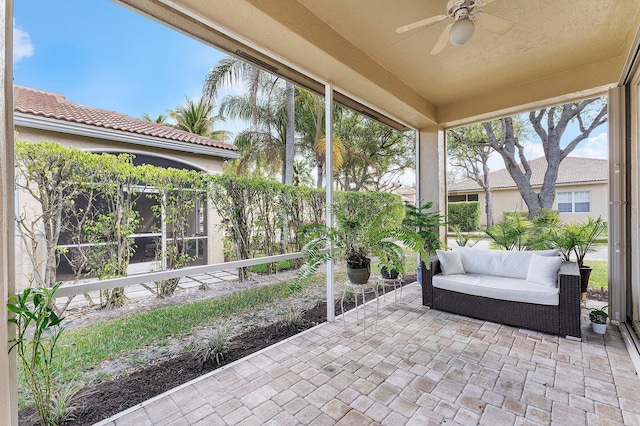 sunroom featuring a ceiling fan