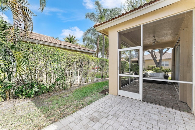 view of patio featuring a sunroom