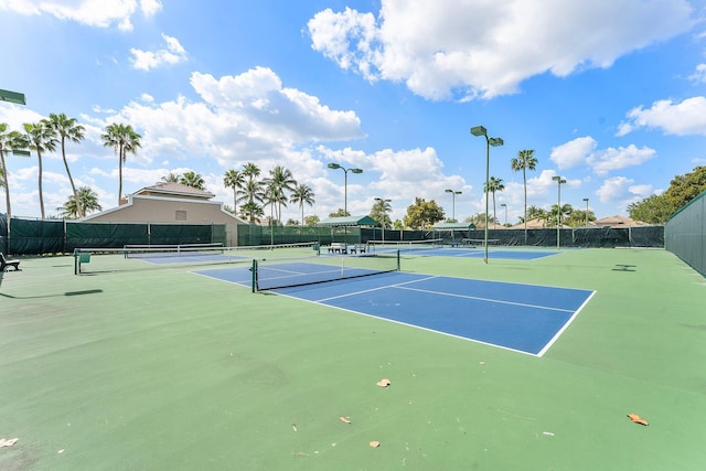 view of tennis court with fence