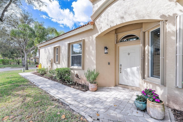 property entrance featuring stucco siding