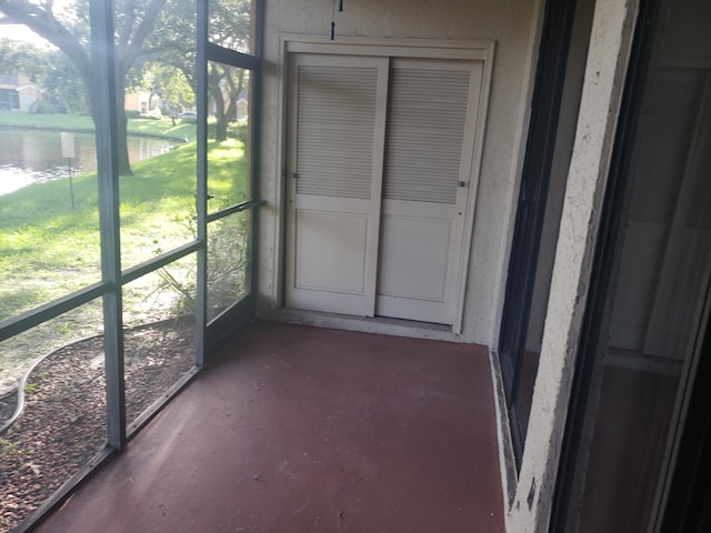 unfurnished sunroom with a water view