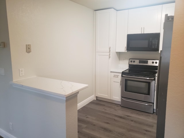 kitchen featuring stainless steel range with electric stovetop, black microwave, white cabinets, and dark wood-style flooring