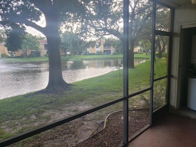 unfurnished sunroom with a water view