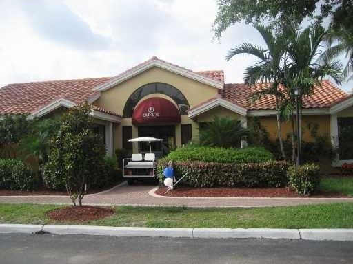 view of front of home with an attached garage, a tile roof, and stucco siding