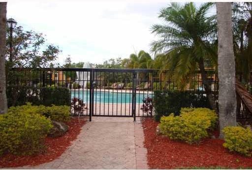 view of gate with a community pool and fence