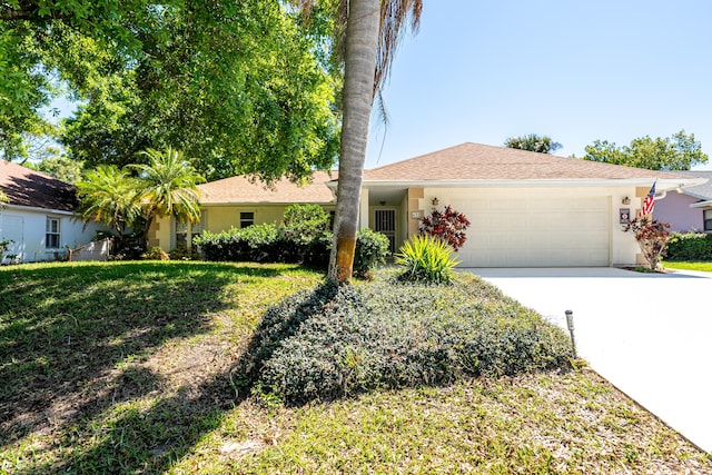 ranch-style home with stucco siding, driveway, a front yard, and a garage