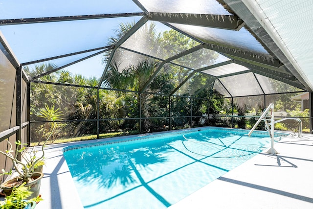 pool with a lanai and a patio area