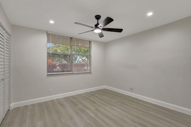 unfurnished bedroom featuring light wood-type flooring, baseboards, a closet, and recessed lighting