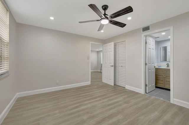 unfurnished bedroom featuring light wood-style flooring, recessed lighting, visible vents, and baseboards