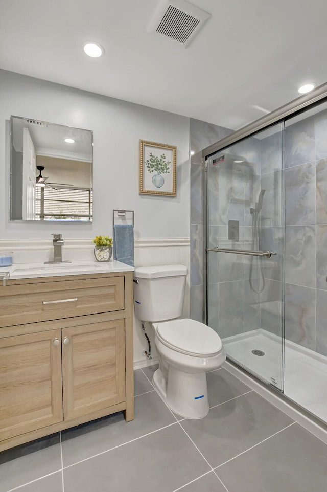 full bath with visible vents, toilet, tile patterned flooring, vanity, and a shower stall