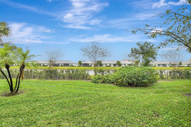 view of yard with a residential view and fence