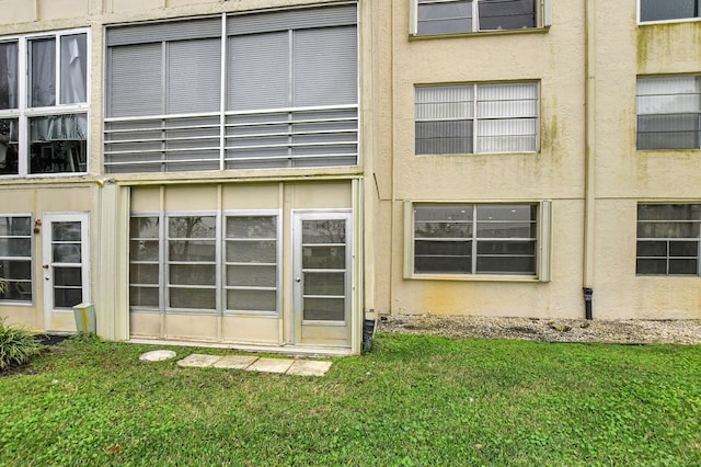 exterior space with a lawn and stucco siding