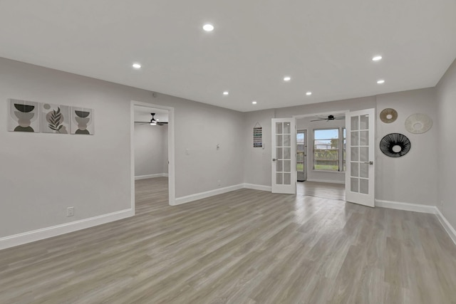 spare room featuring recessed lighting, french doors, light wood-style flooring, and baseboards