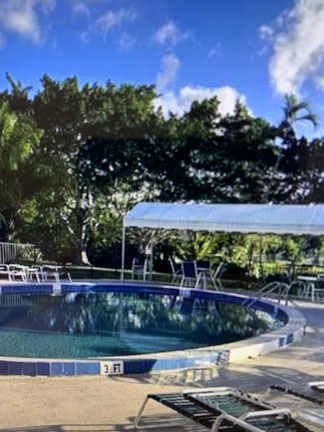 community pool featuring fence