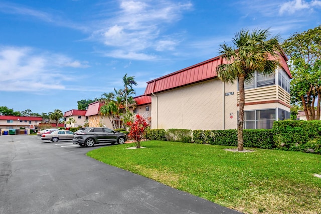 view of building exterior with uncovered parking