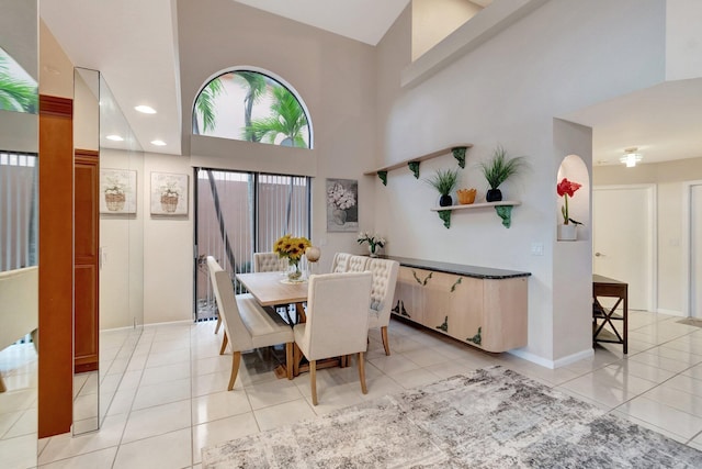 dining space featuring high vaulted ceiling, recessed lighting, light tile patterned floors, and baseboards