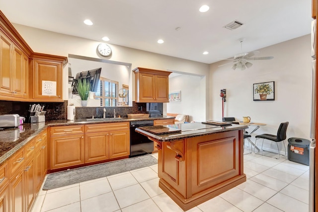 kitchen featuring a sink, tasteful backsplash, a kitchen island, and dishwasher