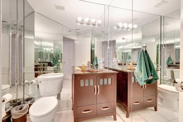 full bath featuring tile patterned flooring, vanity, visible vents, and toilet