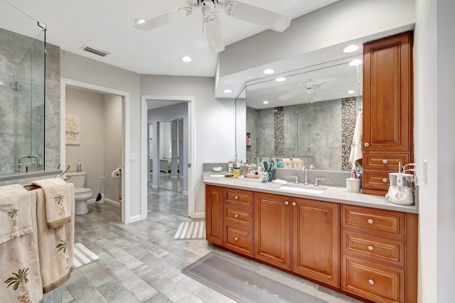 bathroom with ceiling fan, visible vents, toilet, wood finished floors, and a stall shower