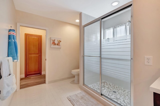 full bathroom featuring baseboards, toilet, recessed lighting, a shower stall, and tile patterned floors
