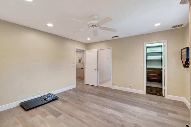unfurnished bedroom featuring visible vents, light wood-style flooring, recessed lighting, and baseboards