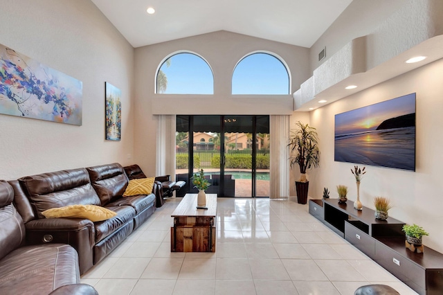 living room featuring high vaulted ceiling, recessed lighting, light tile patterned floors, and visible vents