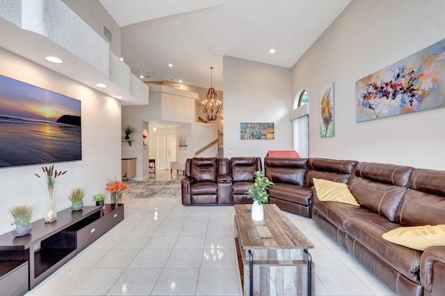 living room with visible vents, light tile patterned floors, a chandelier, recessed lighting, and a towering ceiling
