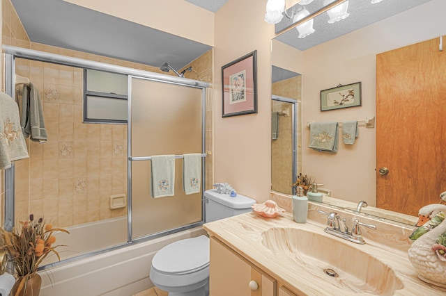 bathroom with enclosed tub / shower combo, a textured ceiling, toilet, and vanity