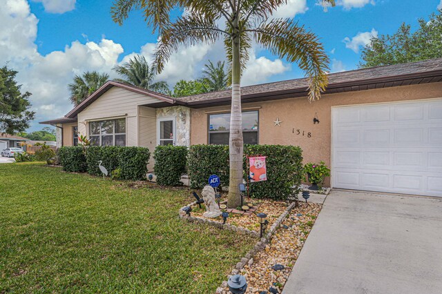 single story home featuring a front lawn, a garage, and stucco siding