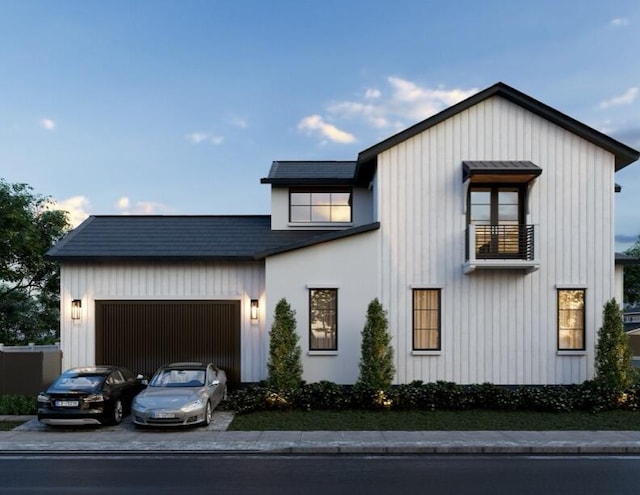 modern farmhouse with driveway, a balcony, and a garage