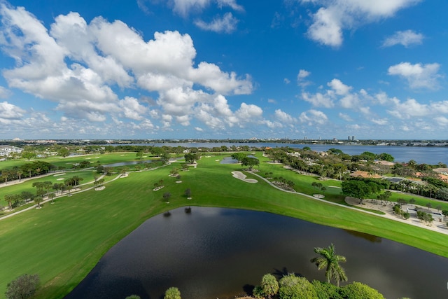 birds eye view of property with a water view and golf course view