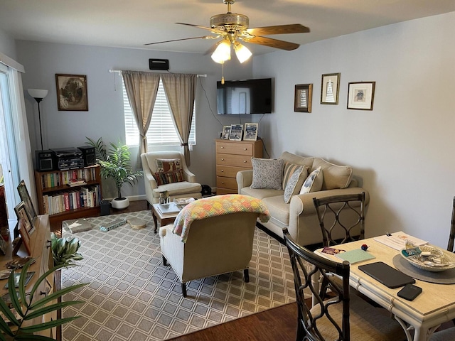 living room featuring a ceiling fan and wood finished floors