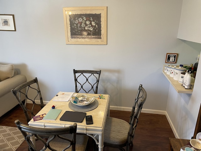 dining room featuring baseboards and wood finished floors