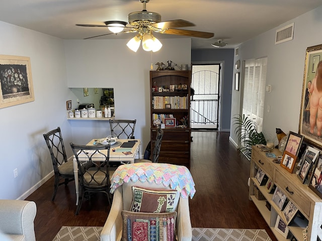 dining space with wood finished floors, visible vents, and baseboards