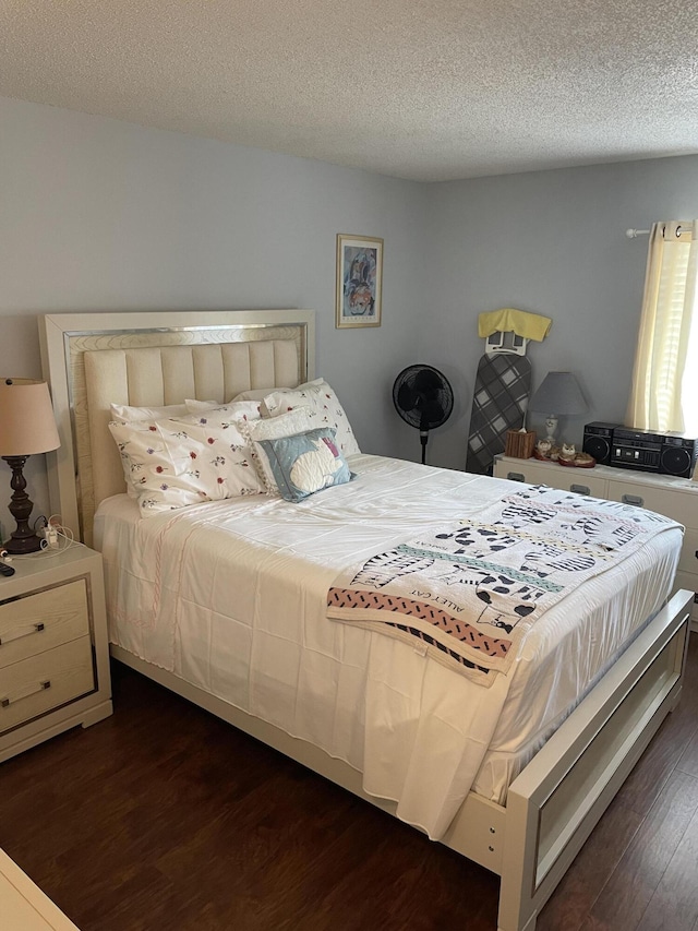 bedroom featuring dark wood-type flooring and a textured ceiling