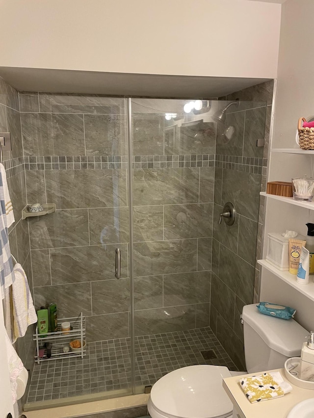 bathroom with toilet and a stall shower