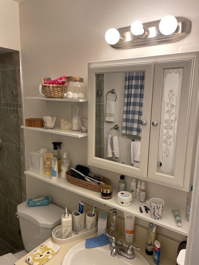 full bathroom with tiled shower and a sink