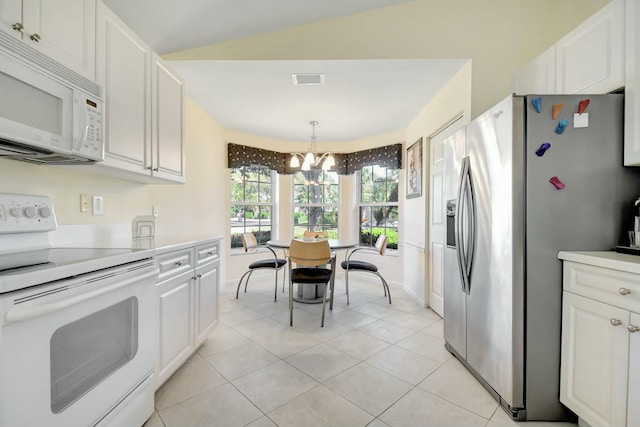 kitchen featuring a chandelier, light tile patterned floors, white appliances, white cabinets, and light countertops